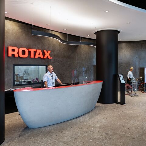Welcome to BRP-Rotax: The modern reception area, which is completed in our anniversary year, 2020, is generously proportioned and welcomes visitors to the exciting world of Rotax.(BRP-Rotax)